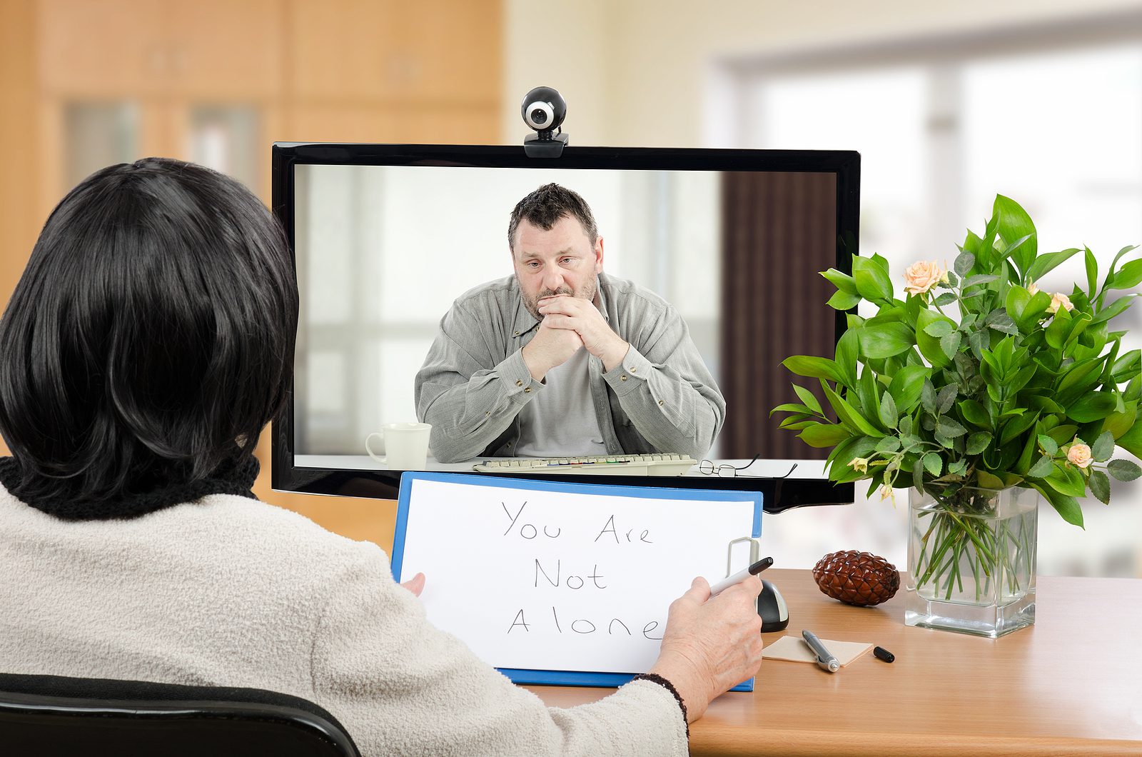 A person attending a virtual therapy session from home
